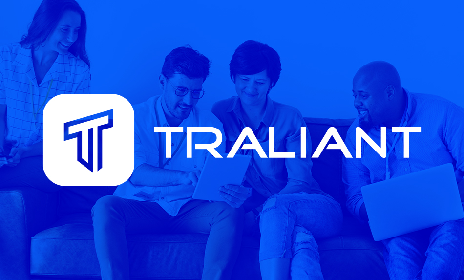 Traliant logo with people in the background, sitting on a couch and looking at a tablet.