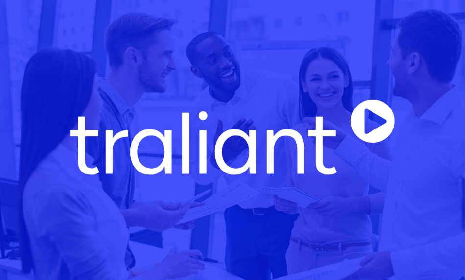 Traliant logo with people in the background, sitting on a couch and looking at a tablet.